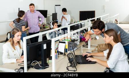 Working process in open space modern office with busy workers Stock Photo