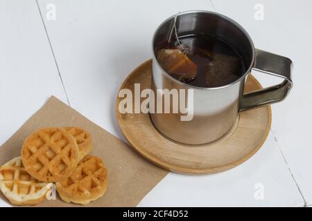 Mug of tea and waffles. On white boards. Autumn still life. Stock Photo