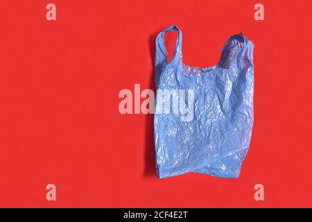 blue plastic bag on red background Stock Photo