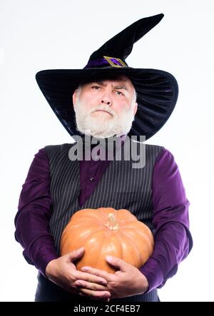 Experienced and wise. Halloween tradition. Wizard costume hat Halloween party. Magician witcher old man. Senior man white beard celebrate Halloween with pumpkin. Cosplay outfit. Magic concept. Stock Photo
