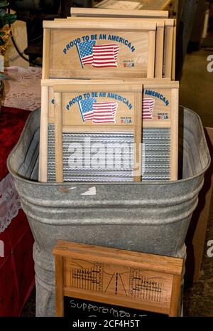 Tub with washboards that will be sent to US servicemen in outlying posts where they must wash their clothes by hand. The kit includes a bucket, washboard, clothesline, pins and soap. Made by Columbus Washboard Co., Logan, Ohio. The company makes 88 different kinds of washboards. Stock Photo