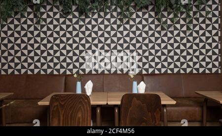 Small tables and comfortable chairs in cozy restaurant Stock Photo