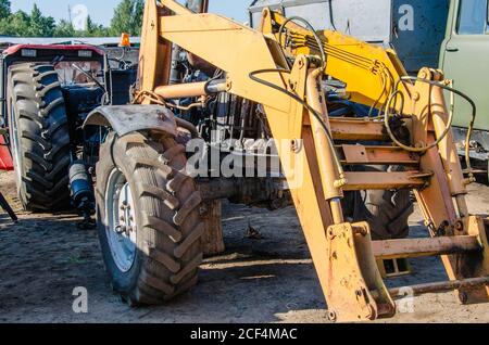 Old rusty tractor's flat back tire. industrial Stock Photo