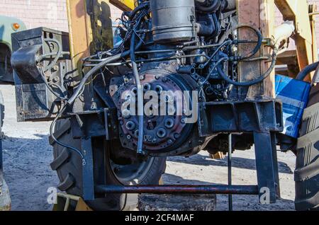 Old rusty tractor's flat back tire. industrial Stock Photo