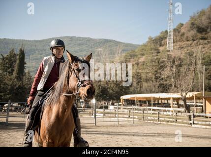 People riding horses in calm creek on sunny day in amazing autumn countryside during lesson Stock Photo