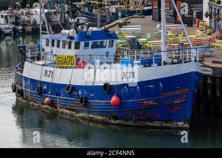 inshore trawlers and fishing boats moored alongside in portsmouth harbour. Stock Photo