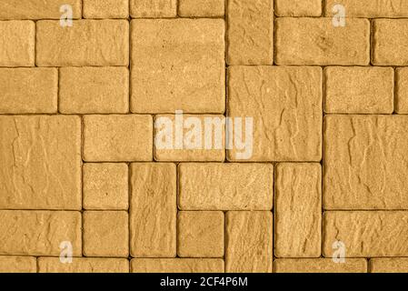 Highly detailed street pavement background with geometric pattern made of square blocks of different sizes with textured rough surface toned in honey Stock Photo