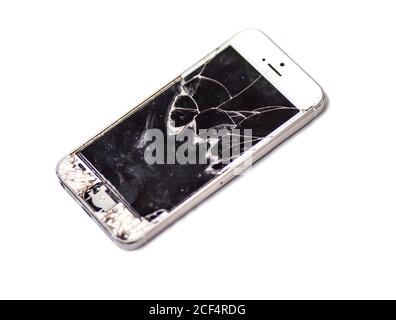 Broken glass of smart phone on the isolated white. Selective focus. Stock Photo