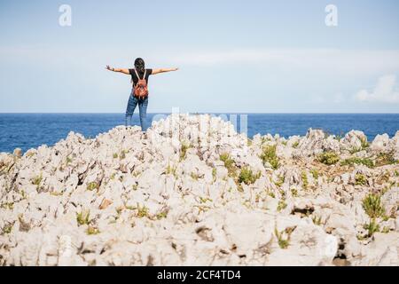 unrecognizable Woman standing on hill in nature Stock Photo