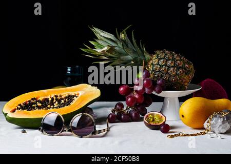 Still life with tropical fruits, gems and sun glasses Stock Photo