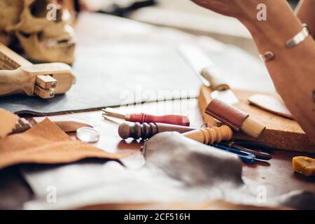 Man working with leather using crafting DIY tools Stock Photo