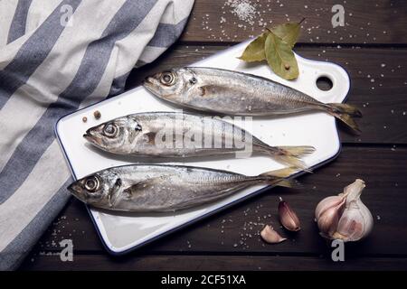 Fresh mackerel fish on cutting board ready to cook. Raw seafood Stock Photo