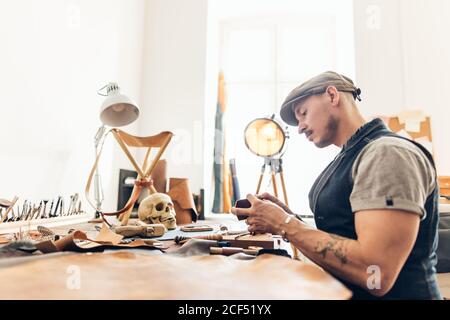 Master a man in an apron bake for skin products. Small business Stock Photo