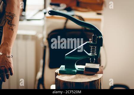 Crafting tools on natural cow leather in the tailoring workshop. Top view. Stock Photo