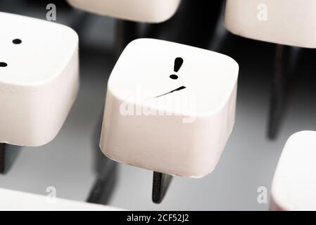 An extreme close-up or a macro shot of a white plastic keyboard keycap from a manual typewriter with shallow depth of field and selective focus. Stock Photo