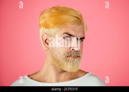 Portrait of blonde serious man has beard and mustache, looks seriously, isolated. Barber with long beard and moustache in barbershop. Bearded man. Stock Photo