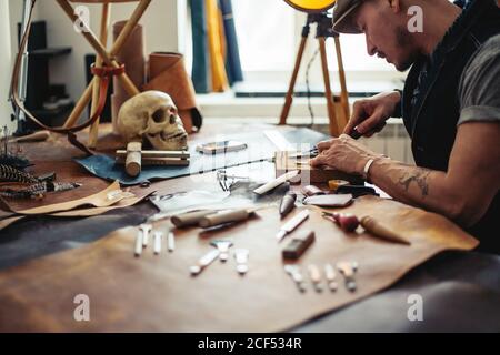 Master a man in an apron bake for skin products. Small business Stock Photo