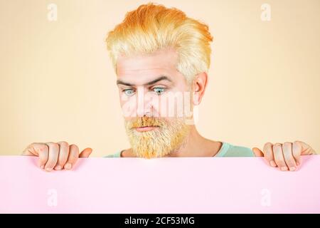 Portrait of man holding sign card. Man show clear paper. Sale. Smiling man holding empty blank paper board with copy space for text. Stock Photo