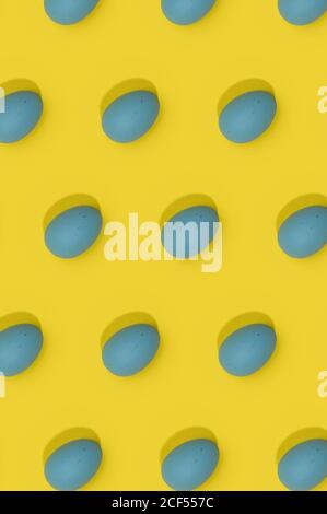 Seamless Easter pattern with colored decorated eggs arranged in rows on yellow background Stock Photo