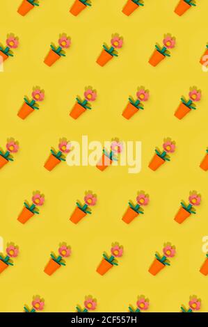 Seamless Easter spring pattern with flowers in red pots arranged in rows on yellow background Stock Photo