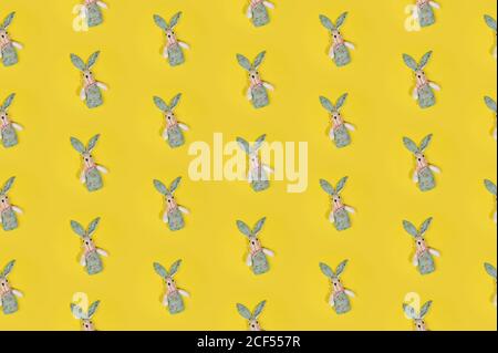 Seamless colorful Happy Easter pattern with cute rabbits on bright yellow background Stock Photo