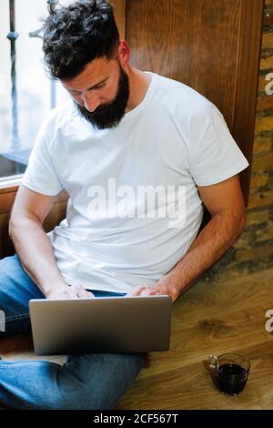 Bearded freelancer using laptop at home Stock Photo