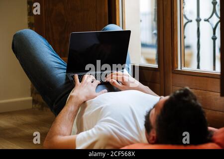 Freelancer using laptop at home Stock Photo