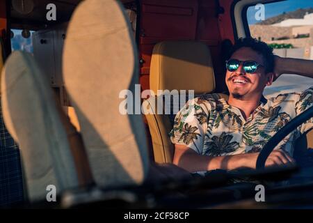 Happy adult man sitting in van Stock Photo