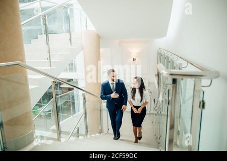 Side view of business people climbing a stair in a building on a morning. Concept of business person's routine. Toned image. Mock up Stock Photo
