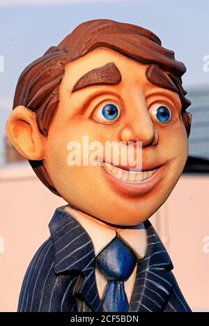 Wide eyed young man represented by a parade puppet or marionette Stock Photo