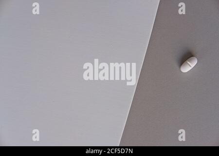 Top view of prescription pill for flu treatment placed on gradient gray sheets of paper Stock Photo