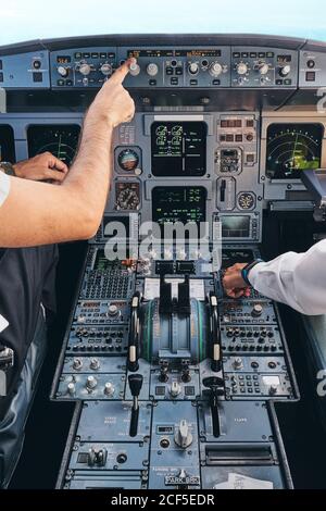 Pilots working in cockpit during flight Stock Photo