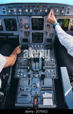 Pilots working in cockpit during flight Stock Photo