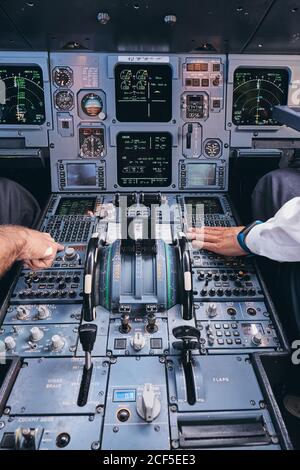 Pilots working in cockpit during flight Stock Photo