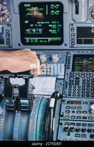 Pilot operating airplane in cockpit Stock Photo