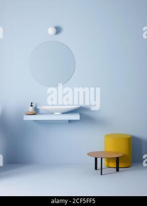 Light bulb and oval mirror hanging on blue wall over sink in minimalist bathroom Stock Photo