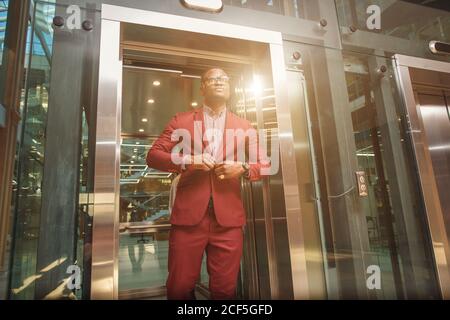 business group comes out from glass Elevator Stock Photo