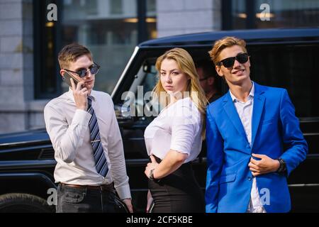 On the way to work. Full length of three smiling business people talking to each other while crossing the street Stock Photo