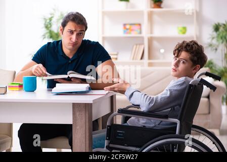 Father and disabled son in the education concept Stock Photo