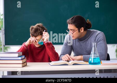 Young teacher and schoolboy in the classroom Stock Photo