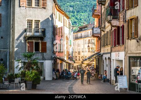Sion Switzerland , 3 July 2020 : People in pedestrian laneway on sunny summer day with dramatic light in Sion old town Switzerland Stock Photo