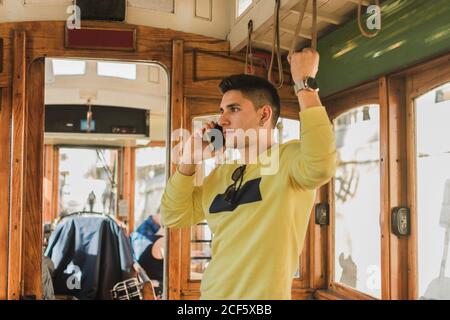 Guy talking on phone riding in train Stock Photo