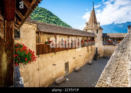 View of Aigle castle from wall walk with flowers and tower during summer in Aigle Vaud Switzerland Stock Photo