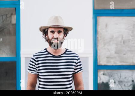 Handsome bearded man standing against old building and looking at camera in La Restinga, El Hierro, on Canary Island Stock Photo