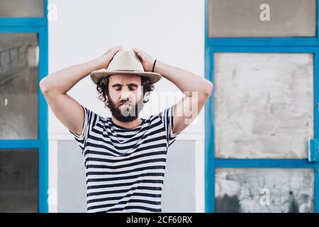 Young male in hat and striped t-shirt Stock Photo