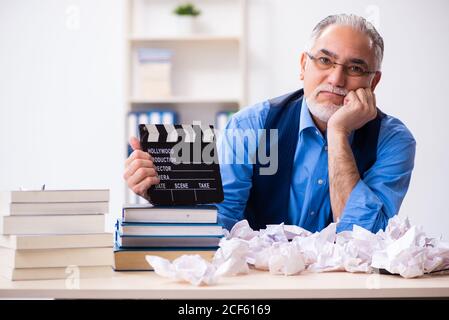 Old male author writing the screenplay Stock Photo