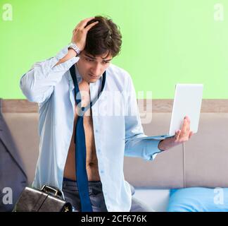 The employee in the bedroom being late for his job Stock Photo