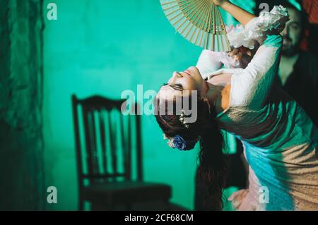 Serious Hispanic flamenco dancer with waver acting on stage Stock Photo