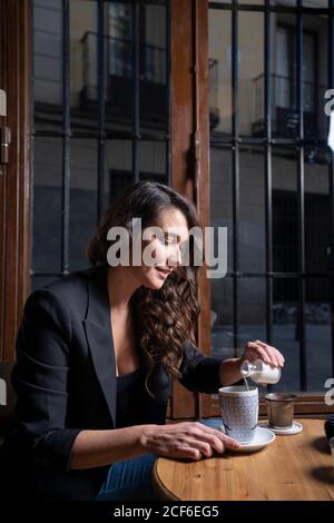 Woman drinking coffee latte in coffee shop Stock Photo