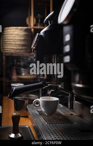 Barista making coffee using a coffee maker Stock Photo